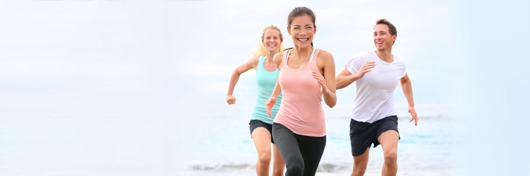 People running on the beach in CA l dentist near me van nuys