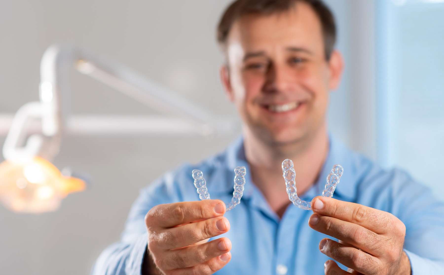 A Dentist holding pair of Invisalign in Van Nuys. CA