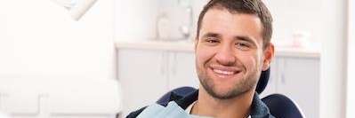 A gentleman smiling after comprehensive oral surgery in The Dental Care Center, Van Nuys, California