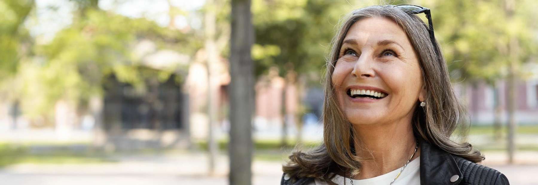 A woman smiling after getting dental implants in Van Nuys: