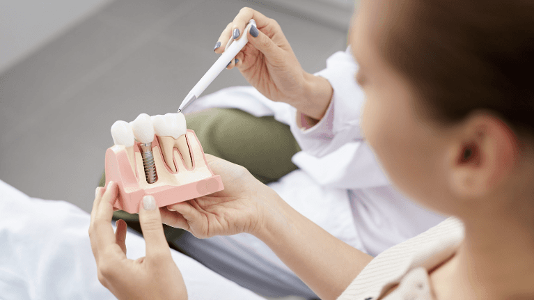 A woman being shown dental implant depiction in Van Nuys:
