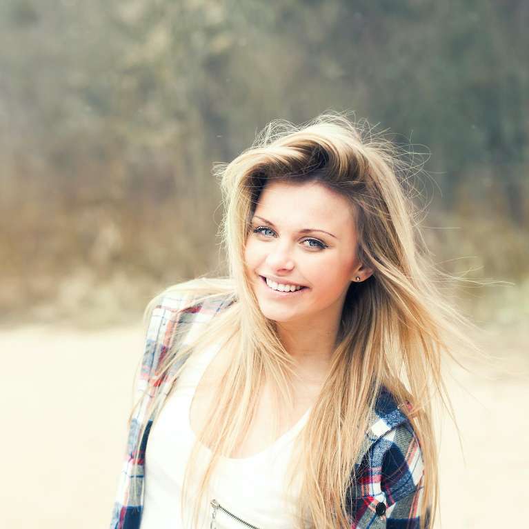 A happy lady after visting a Top Van Nuys Teeth Whitening Dentist