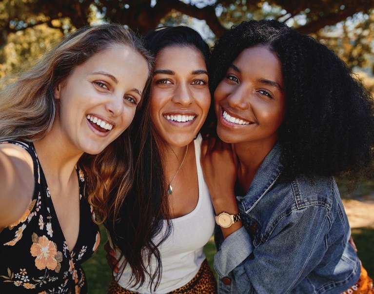 A group of women smiling after getting teeth whitening service in Van Nuys
