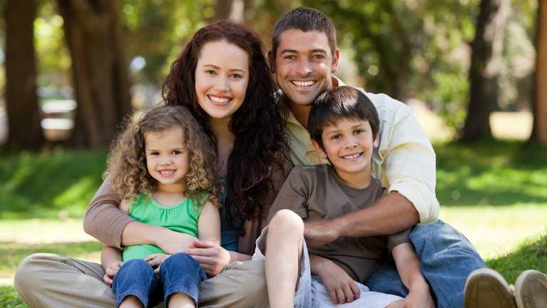 A Family Smiling Together after Dental check up in The Dental Care Center, Van Nuys, California