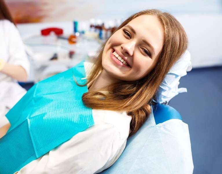 A female patient smiling after getting an Oral Surgery in Van Nuys, CA