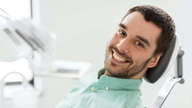 A gentleman smiling after teeth whitening in The Dental Care Center, Van Nuys, California
