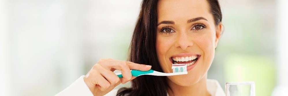A woman brushing her teeth in Van Nuys. CA