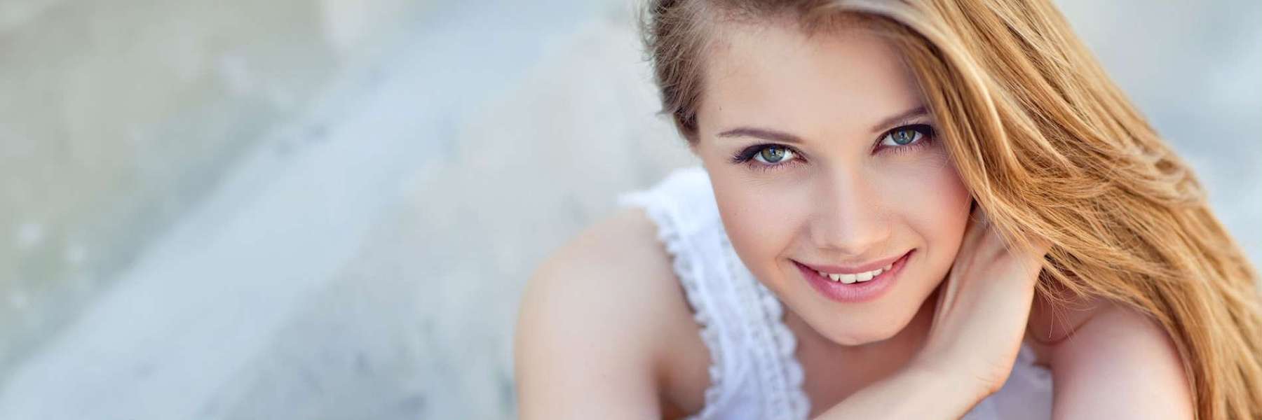 A young woman smiling after getting a Cosmetic Dentistry in Van Nuys, CA