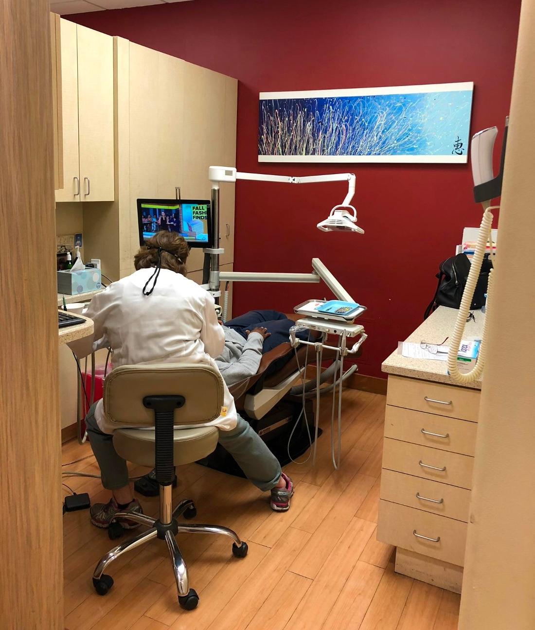 Van Nuys CA dentist performing dental exam at The Dental Care Center