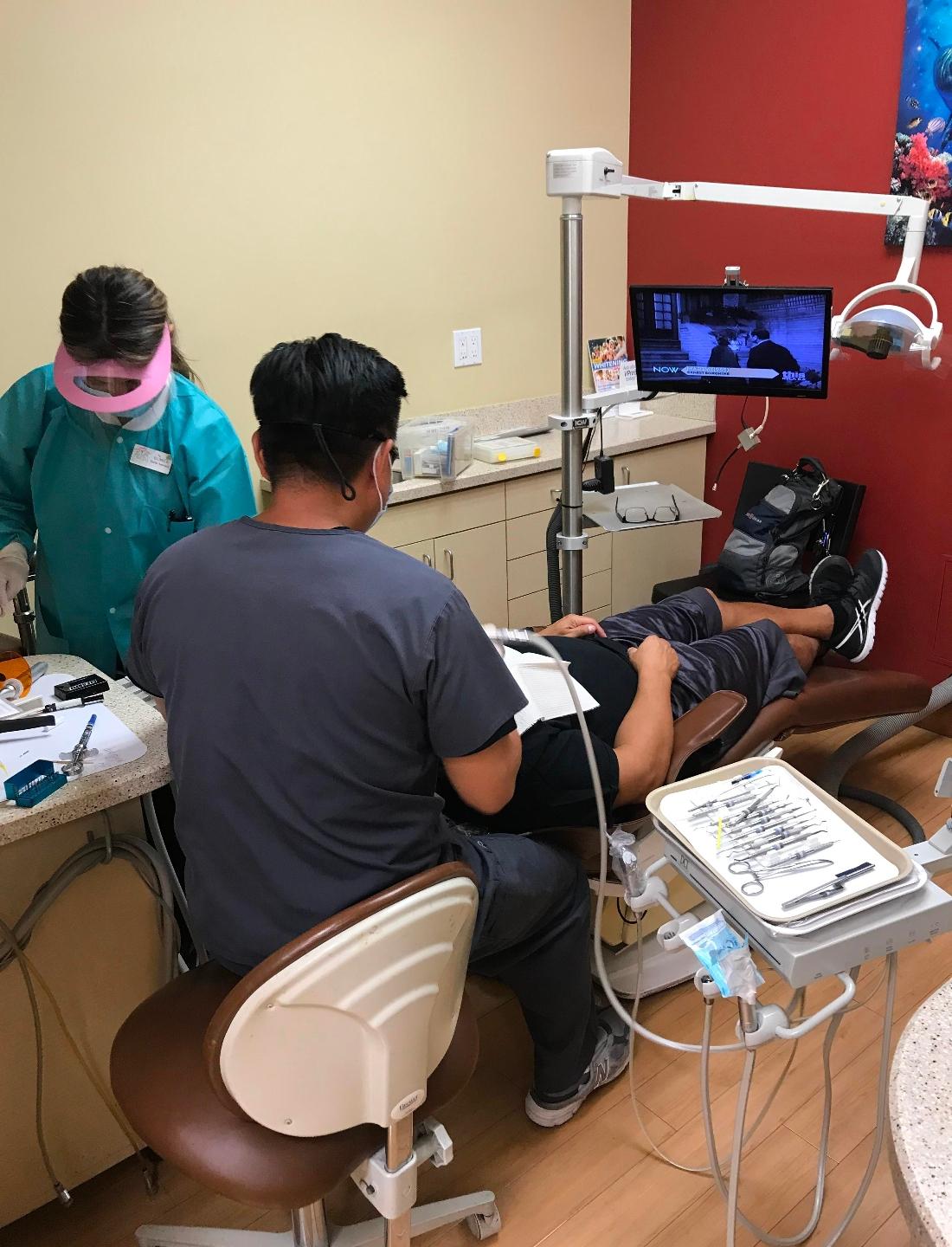 91405 dentist performing a procedure at The Dental Care Center